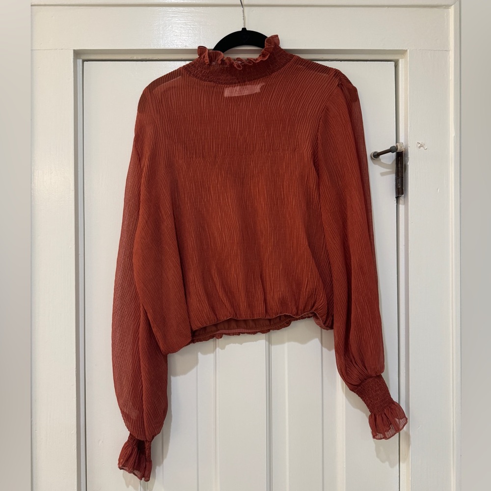Rust orange ruffle neck blouse
